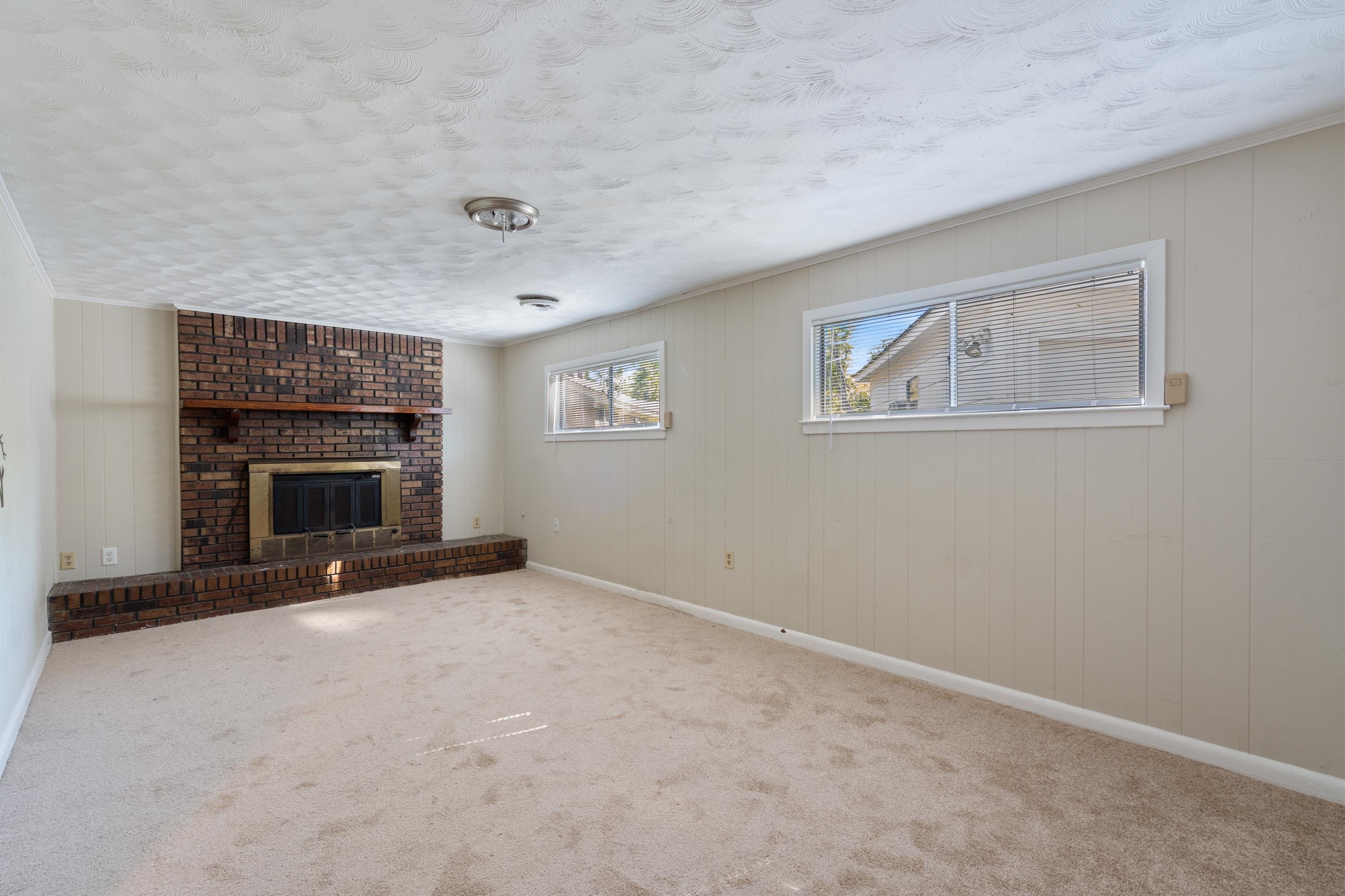 4797 Helene Road Memphis, TN 38117 - Photo 11 of 21 an empty room with windows and fireplace