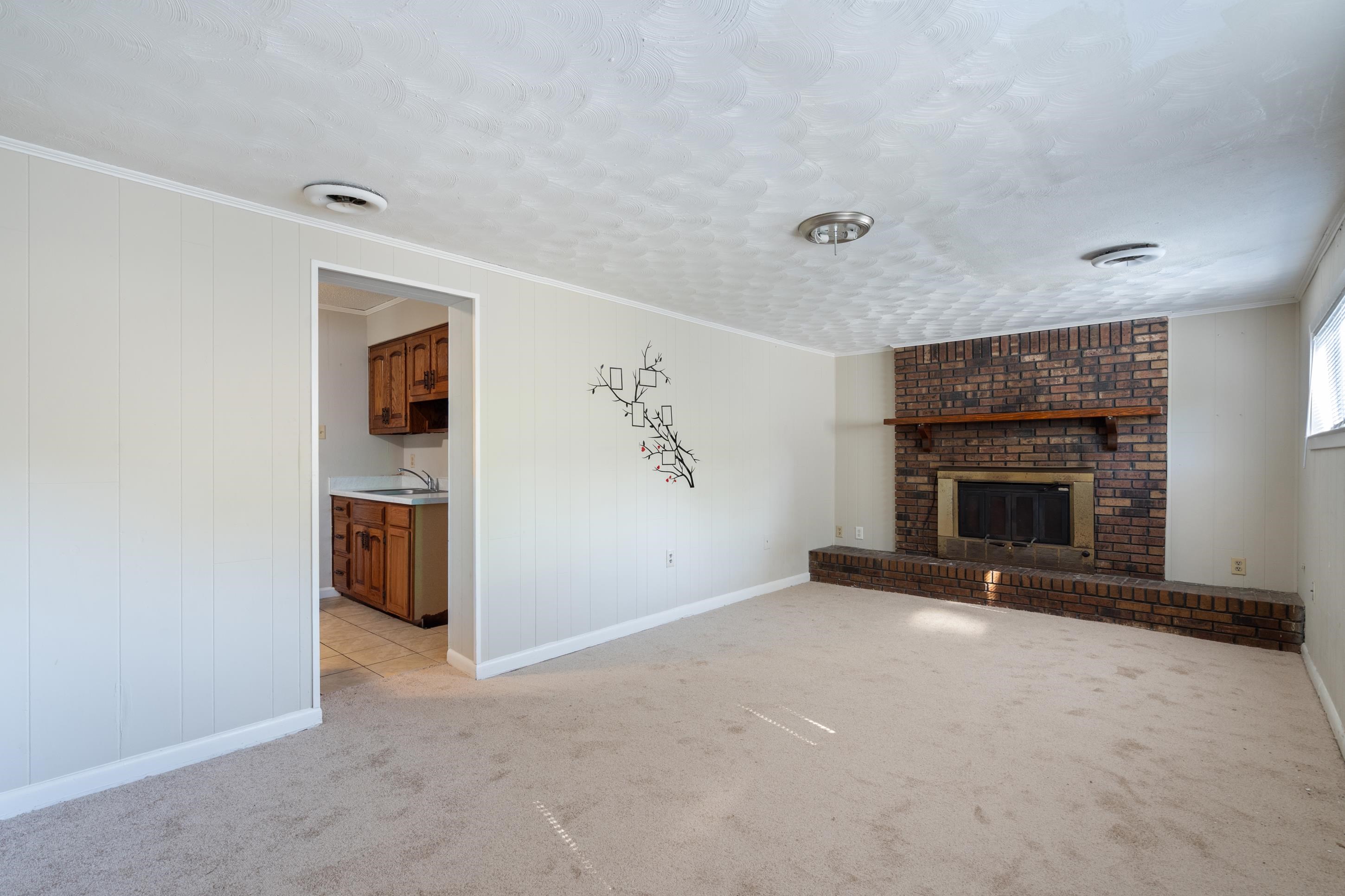 4797 Helene Road Memphis, TN 38117 - Photo 13 of 21 a view of an empty room with a fireplace