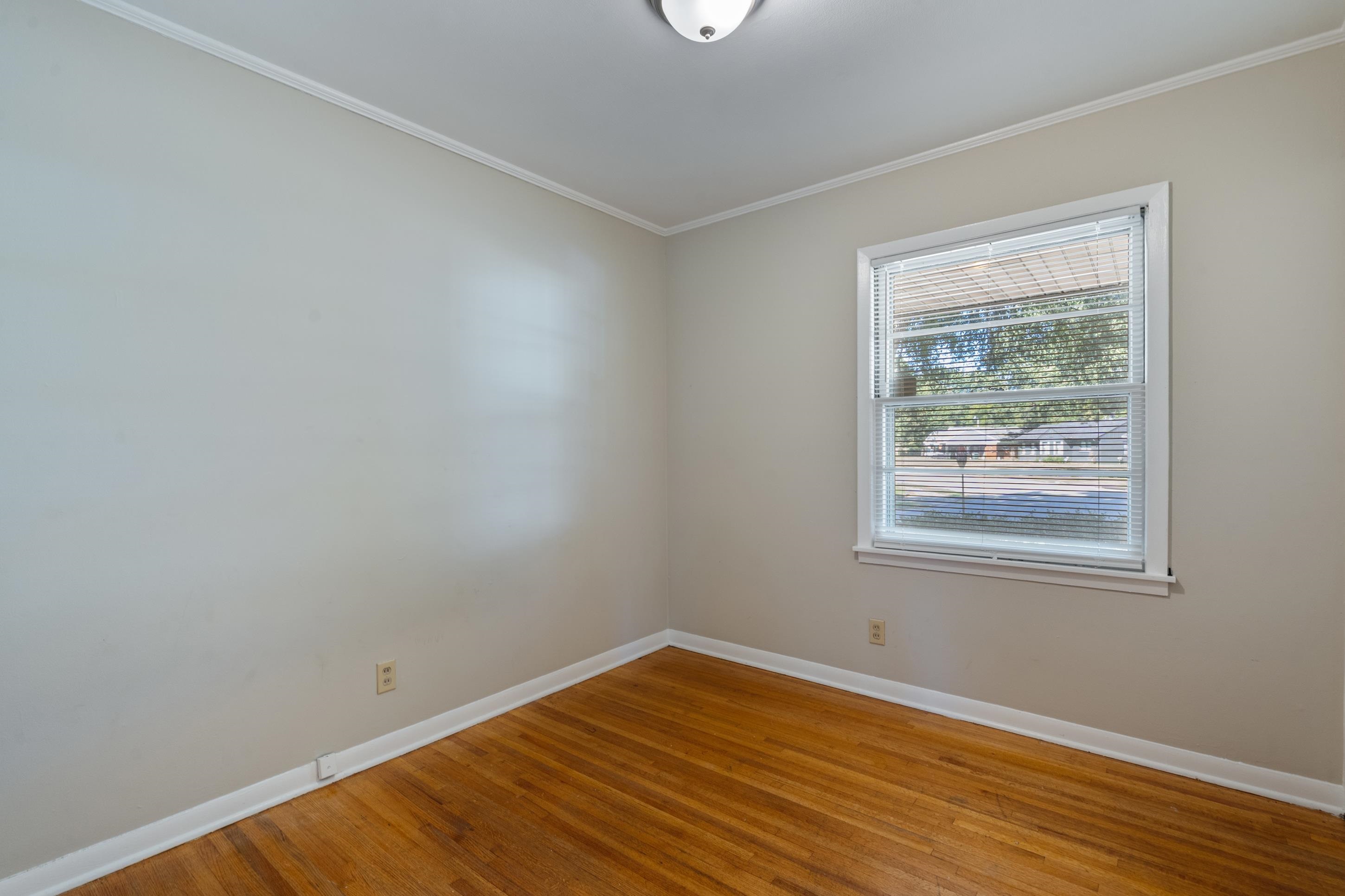 4797 Helene Road Memphis, TN 38117 - Photo 14 of 21 a view of an empty room with wooden floor and a window