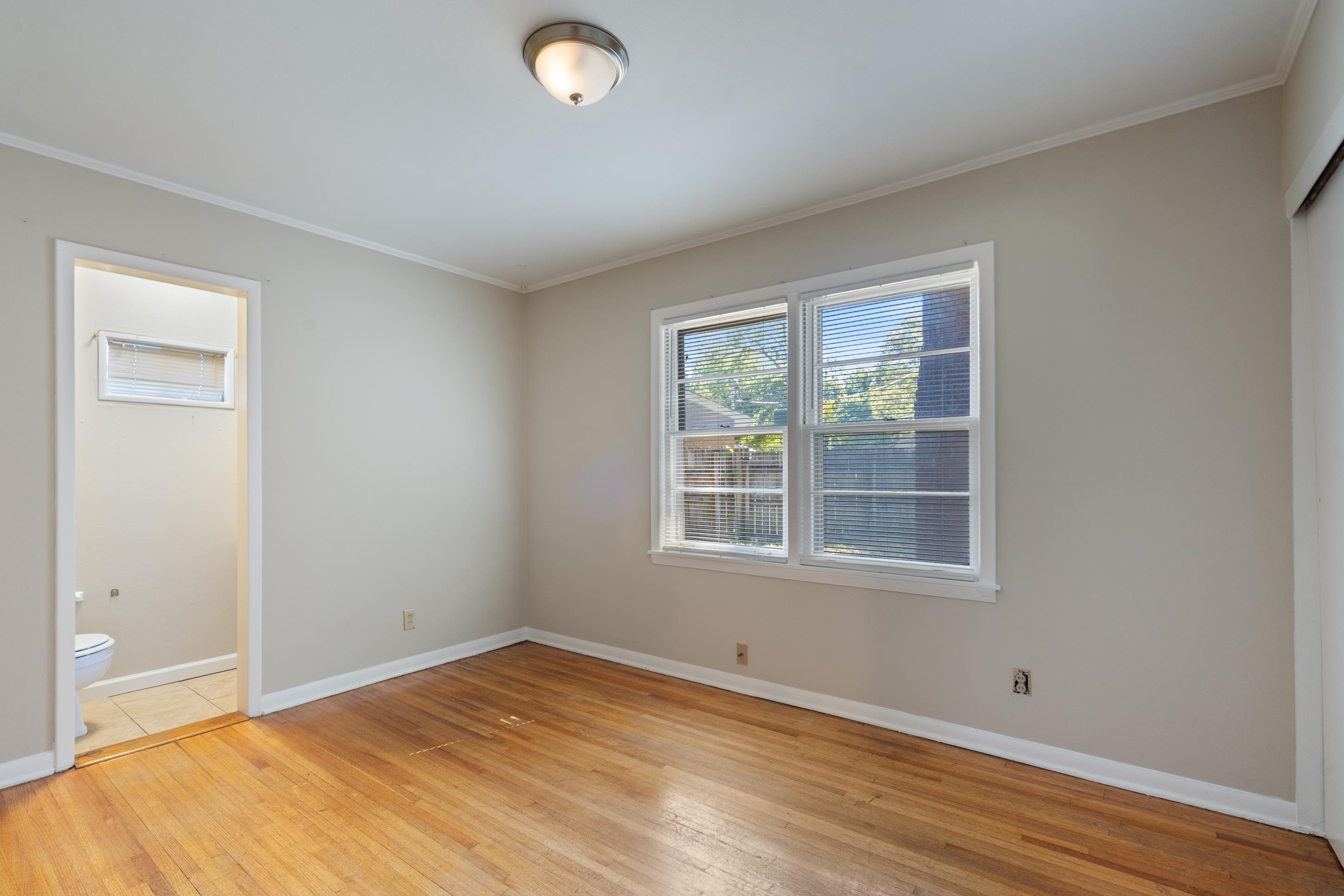 4797 Helene Road Memphis, TN 38117 - Photo 16 of 21 an empty room with wooden floor and windows