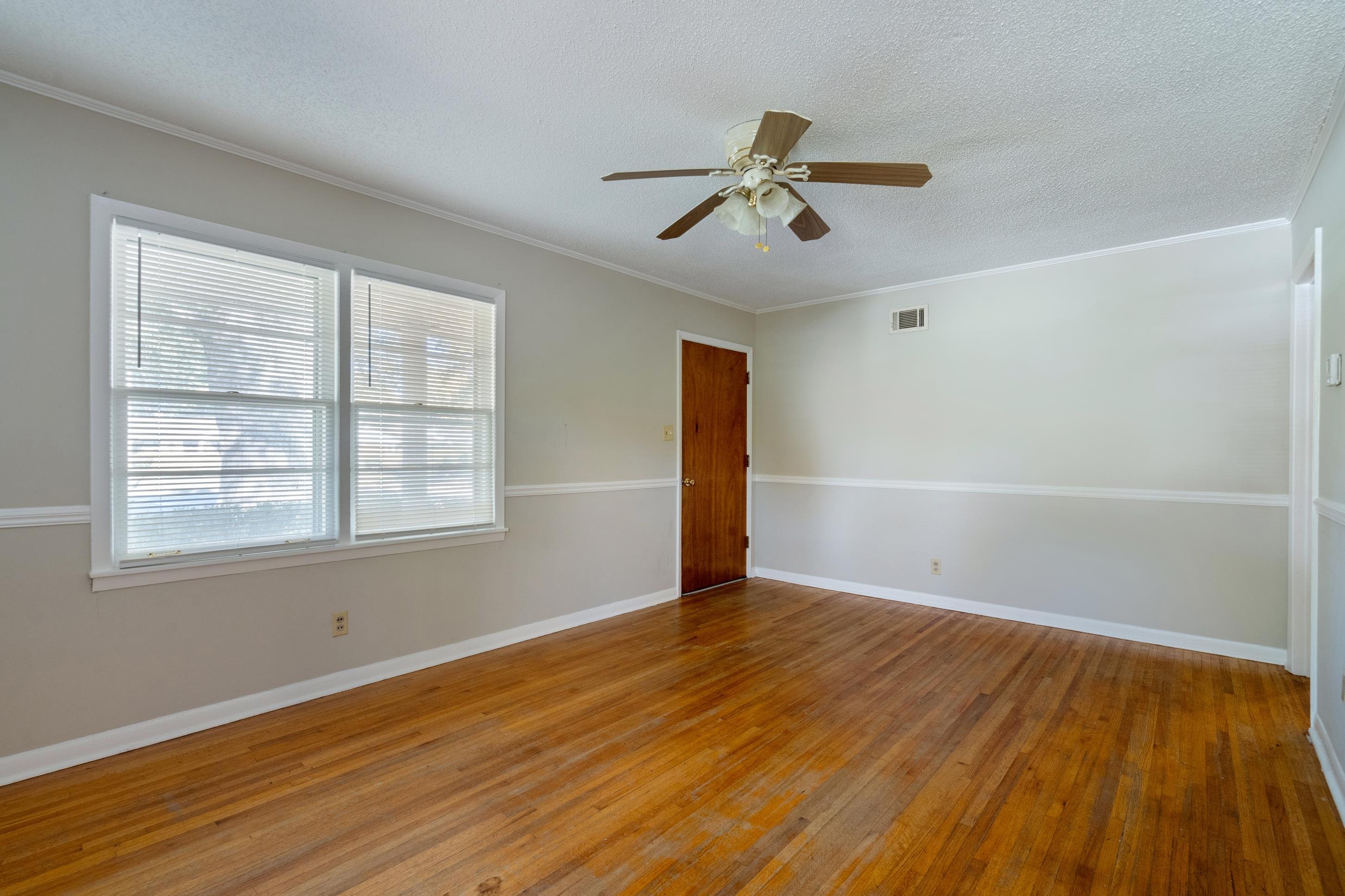 4797 Helene Road Memphis, TN 38117 - Photo 6 of 21 a view of an empty room with wooden floor and a window