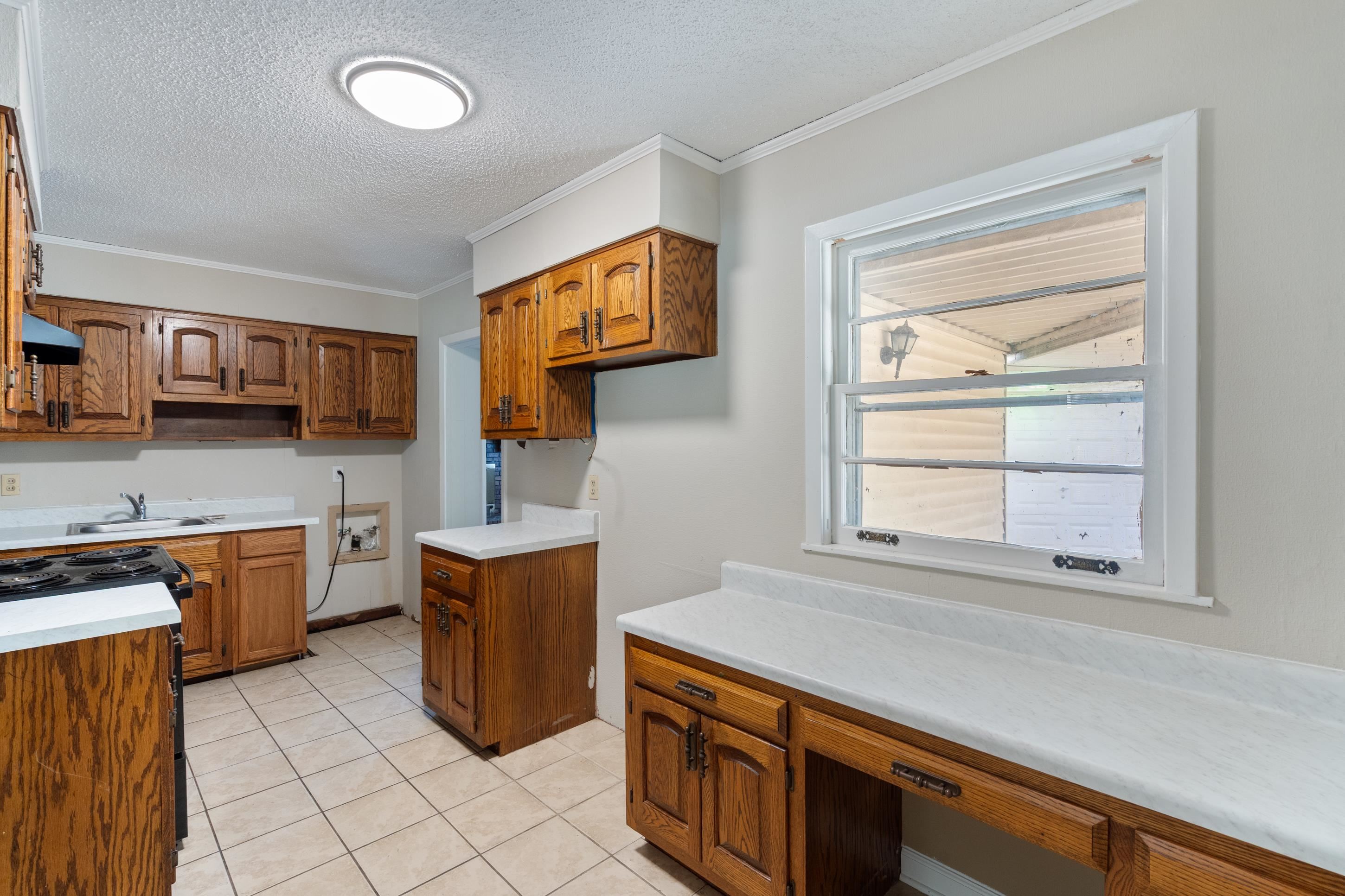 4797 Helene Road Memphis, TN 38117 - Photo 8 of 21 a kitchen with stainless steel appliances a stove a sink and a microwave