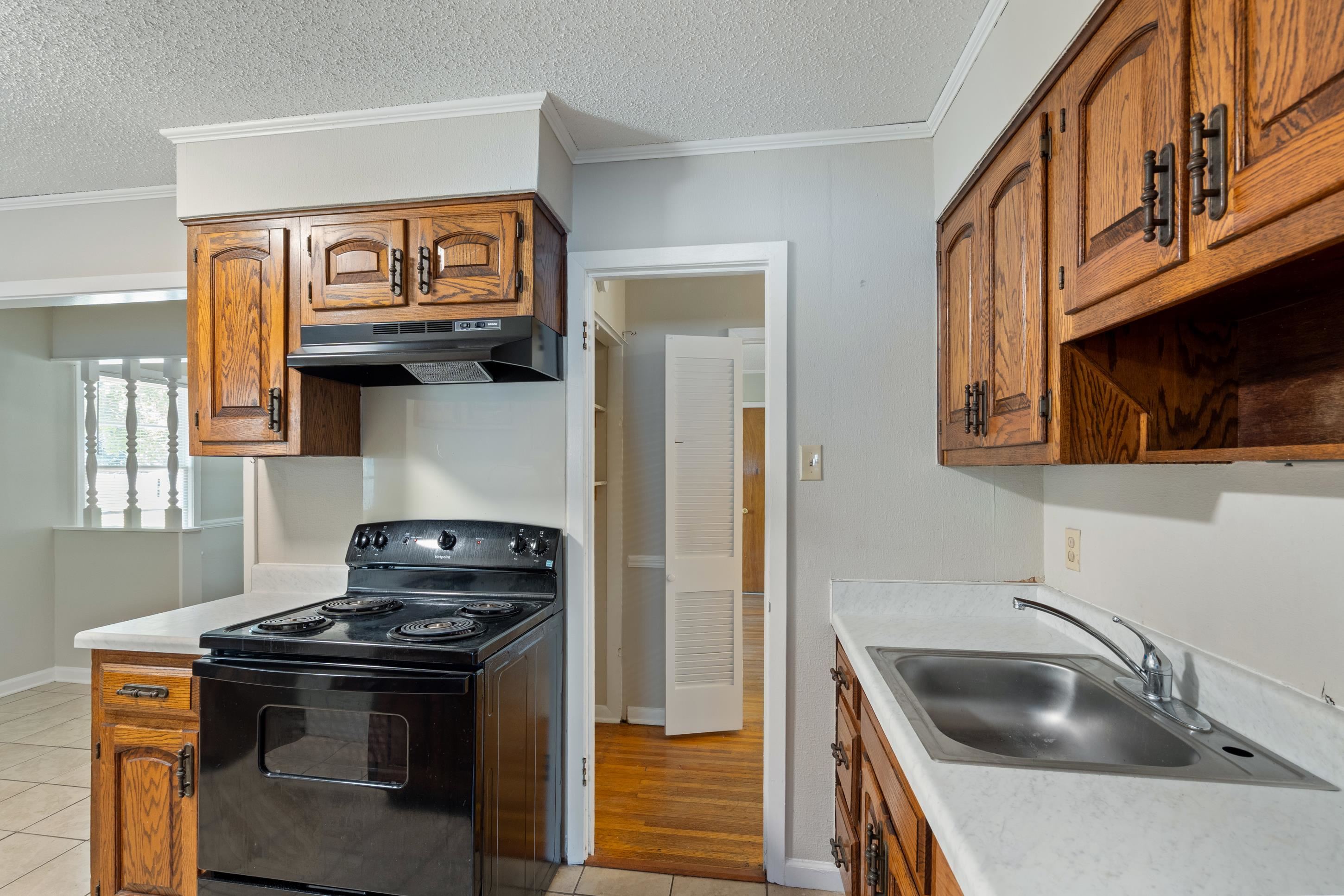 4797 Helene Road Memphis, TN 38117 - Photo 10 of 21 a kitchen with a stove and a sink