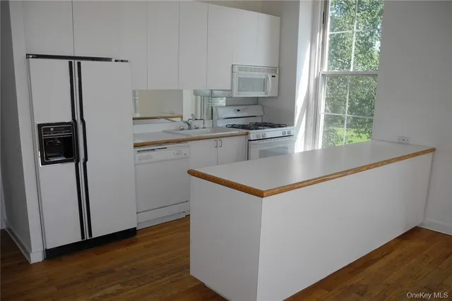 a kitchen with stainless steel appliances a refrigerator and a stove top oven