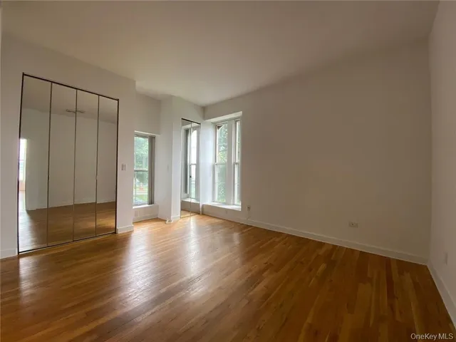 a kitchen with stainless steel appliances a refrigerator a sink a stove a microwave a counter space and a window