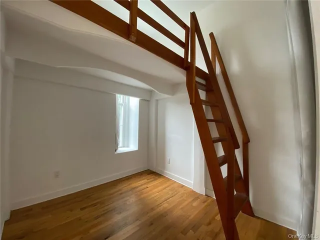 a bedroom with a bed and a chair