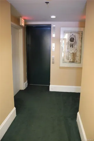 a view of a small space with wooden floor and a window