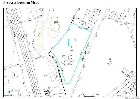 a picture of a room with a white comforter and a large window