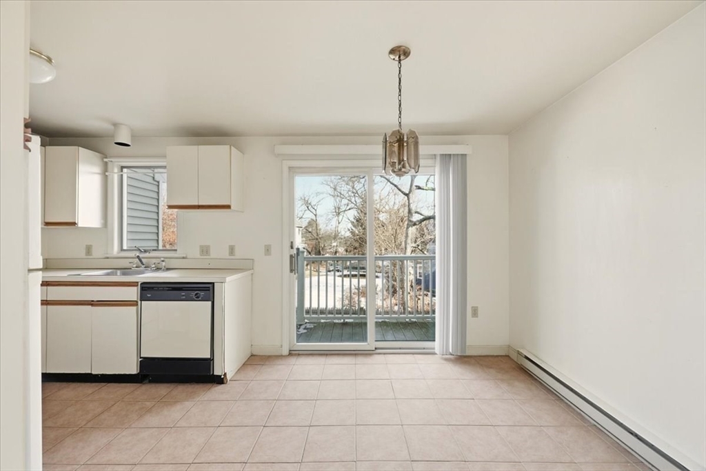 87 Victoria Heights Road, Unit 87 Boston, MA 02136 - Photo 14 of 32 a kitchen with granite countertop white cabinets and white appliances