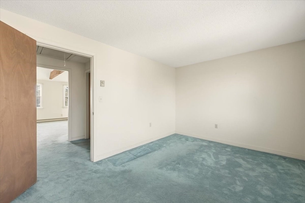 87 Victoria Heights Road, Unit 87 Boston, MA 02136 - Photo 21 of 32 an empty room with a natural light