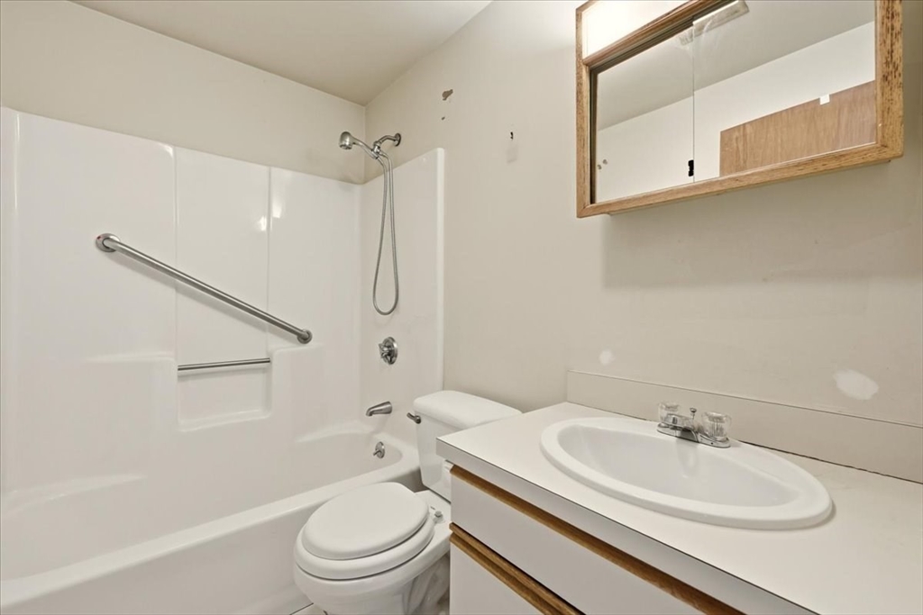 87 Victoria Heights Road, Unit 87 Boston, MA 02136 - Photo 22 of 32 a bathroom with a sink a toilet and a mirror