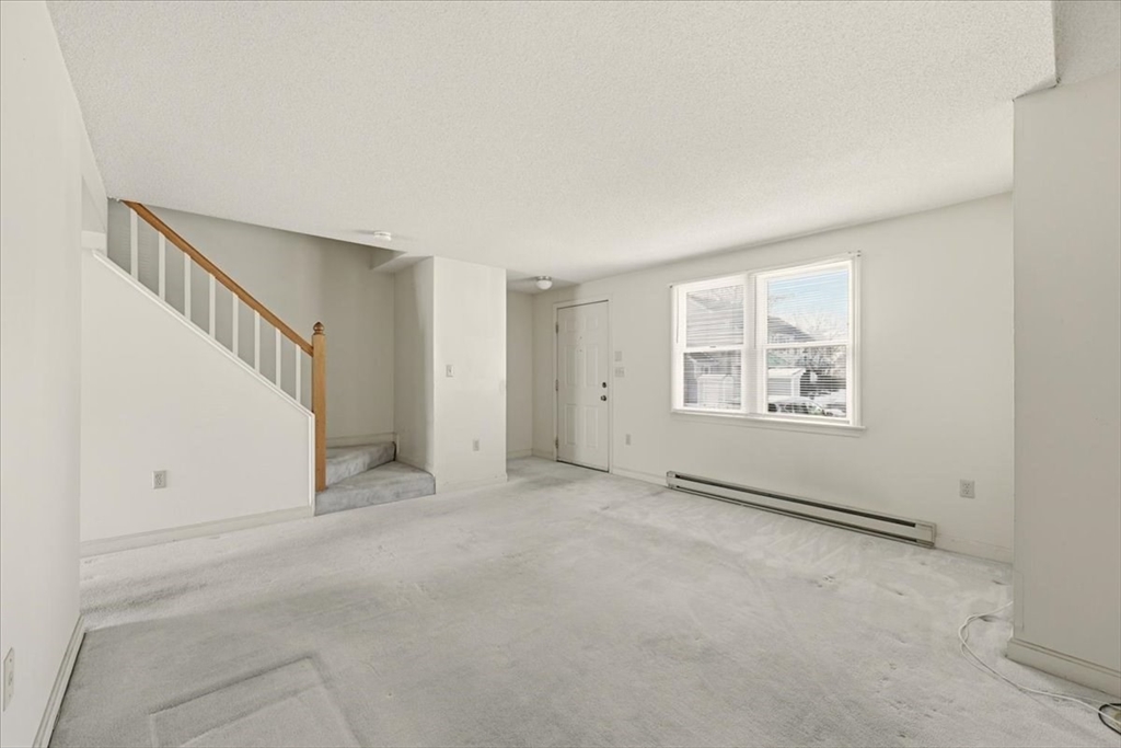 87 Victoria Heights Road, Unit 87 Boston, MA 02136 - Photo 4 of 32 an empty room with windows