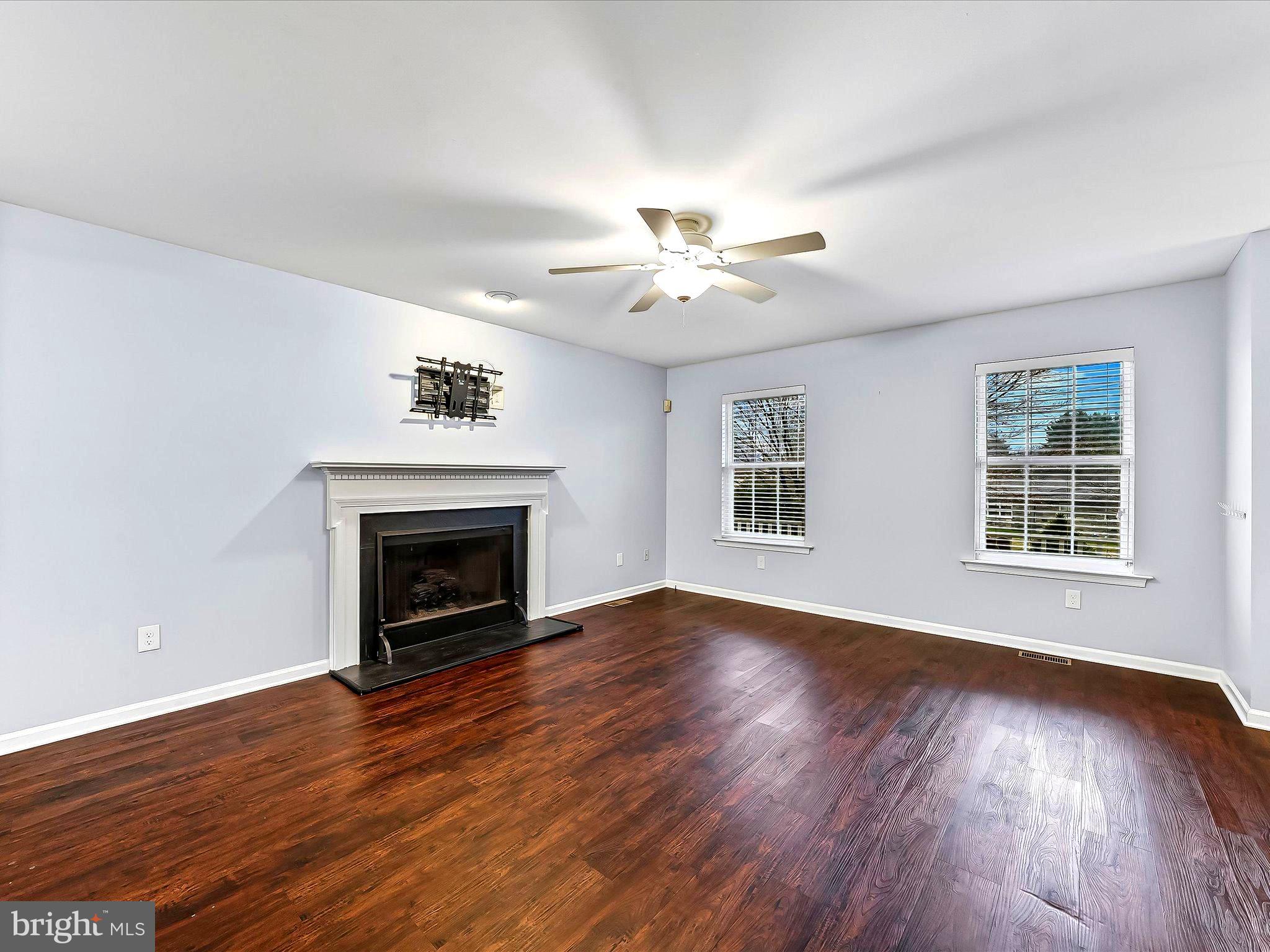 2410 Larkin Road Upper Chichester, PA 19061 - Photo 12 of 50 a view of an empty room with wooden floor fireplace and a window