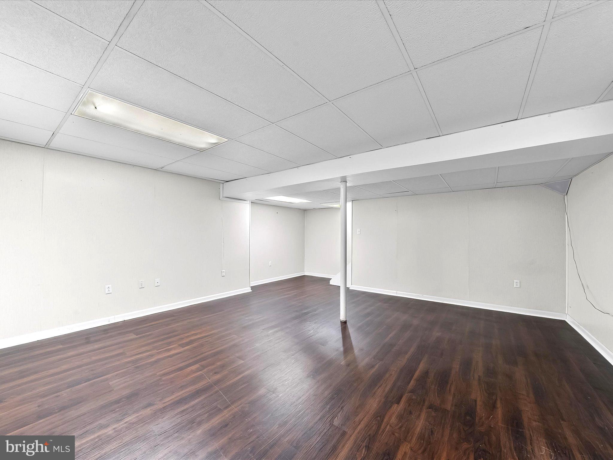 2410 Larkin Road Upper Chichester, PA 19061 - Photo 39 of 50 an empty room with wooden floor