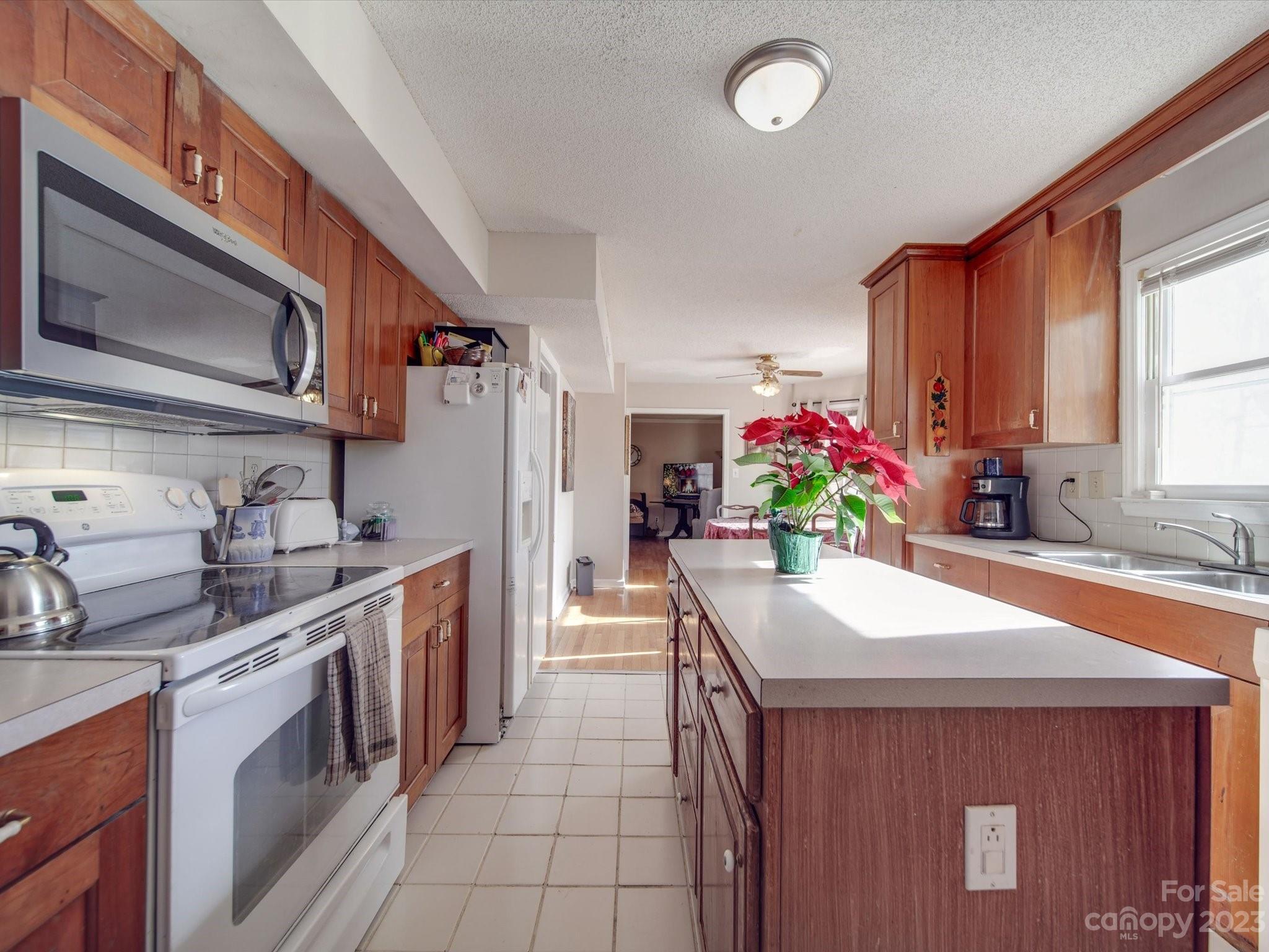 8009 Lighthouse Way Indian Trail, NC 28079 - Photo 11 of 26 a kitchen with stainless steel appliances kitchen island granite countertop a sink stove and cabinets
