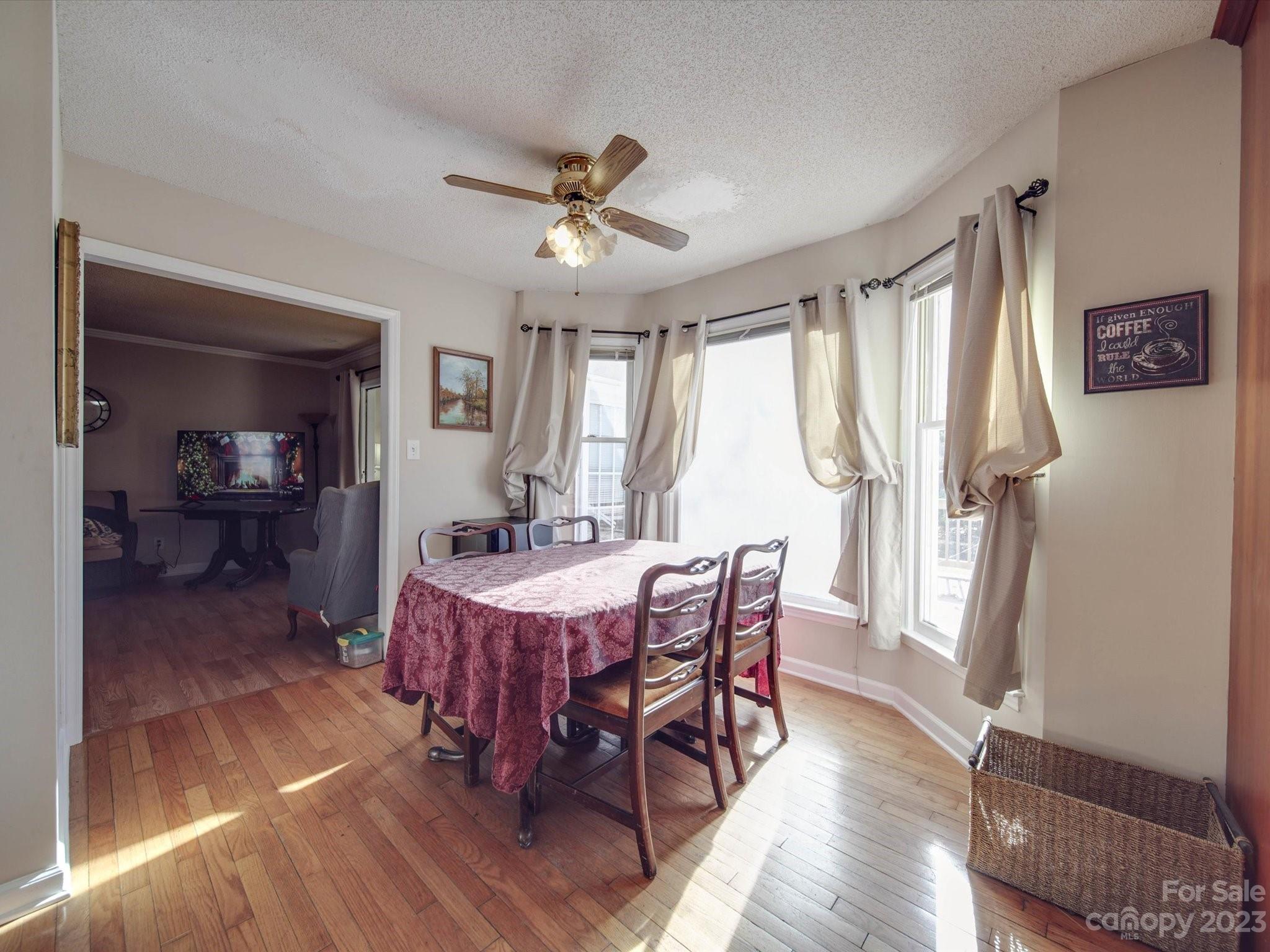 8009 Lighthouse Way Indian Trail, NC 28079 - Photo 12 of 26 a view of a dining room with furniture window and wooden floor