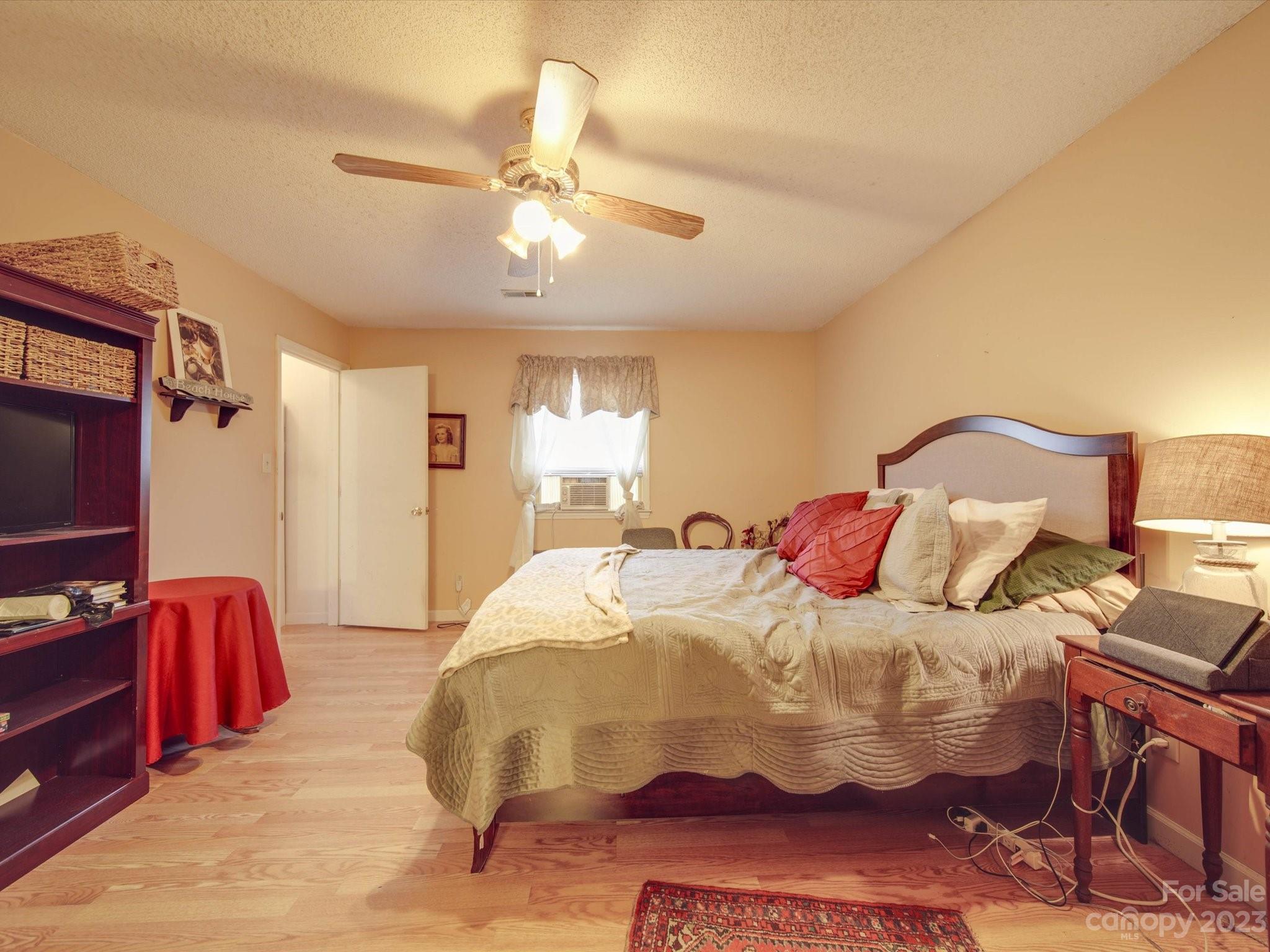8009 Lighthouse Way Indian Trail, NC 28079 - Photo 14 of 26 a bedroom with a bed and a chandelier