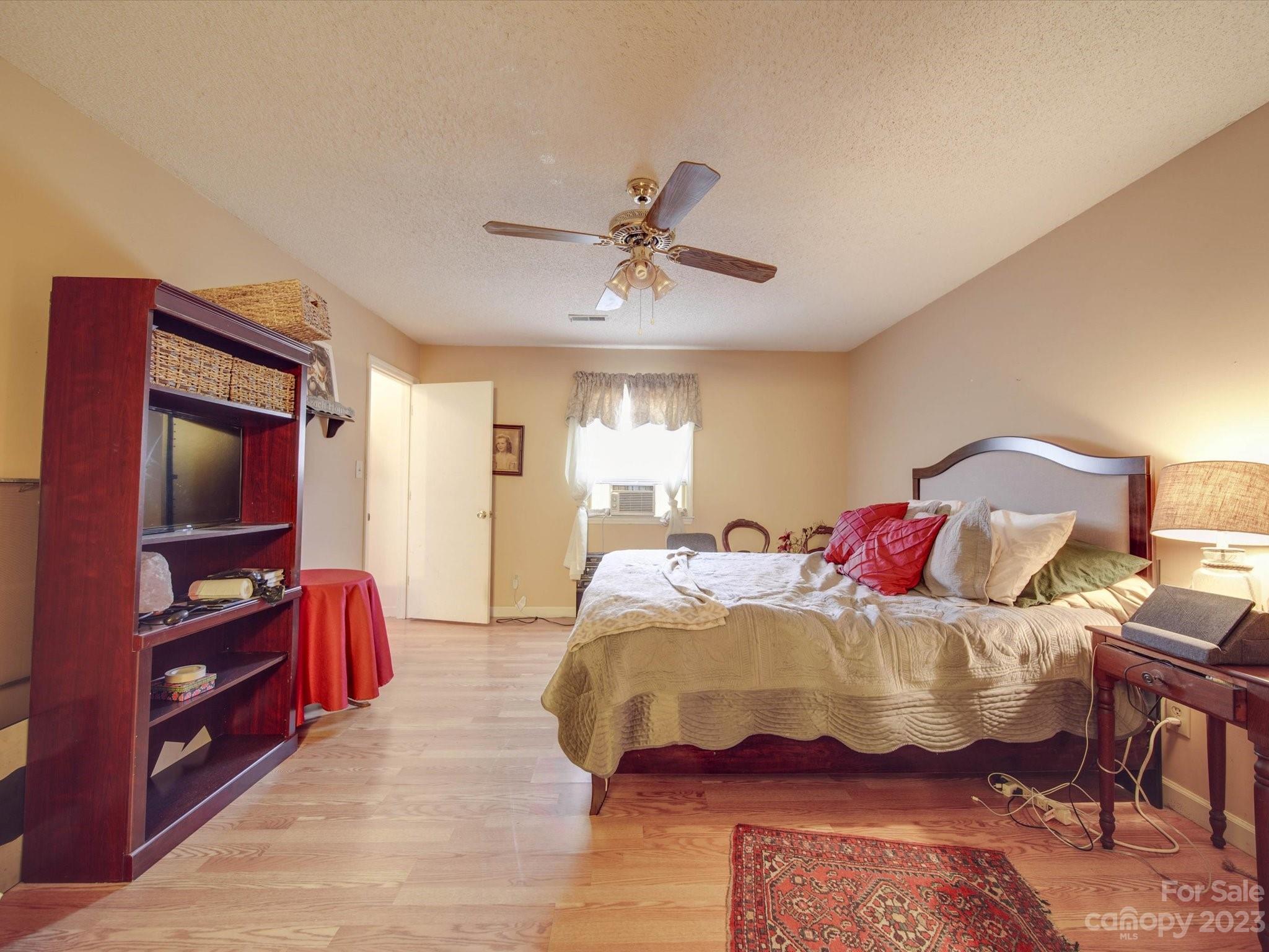 8009 Lighthouse Way Indian Trail, NC 28079 - Photo 15 of 26 a bedroom with a bed and wooden floor