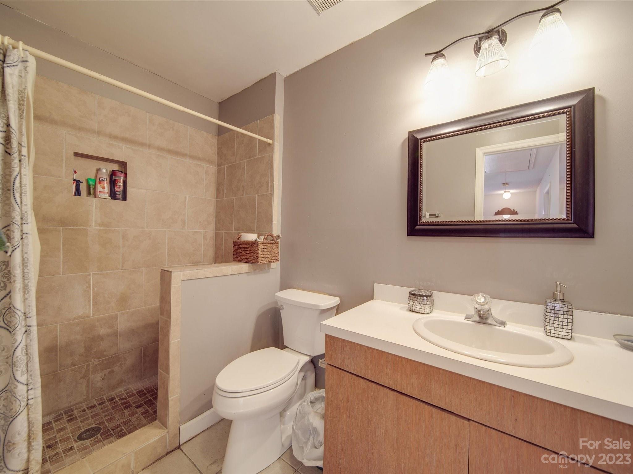 8009 Lighthouse Way Indian Trail, NC 28079 - Photo 16 of 26 a bathroom with a toilet sink and mirror