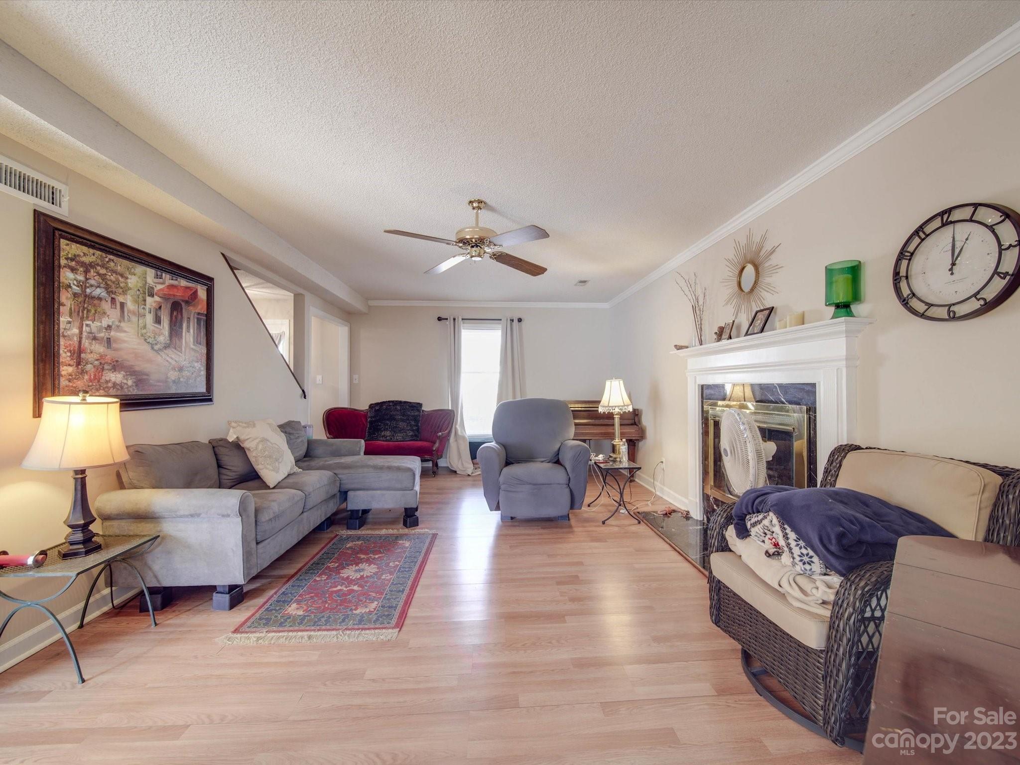 8009 Lighthouse Way Indian Trail, NC 28079 - Photo 3 of 26 a living room with furniture a fireplace and a flat screen tv