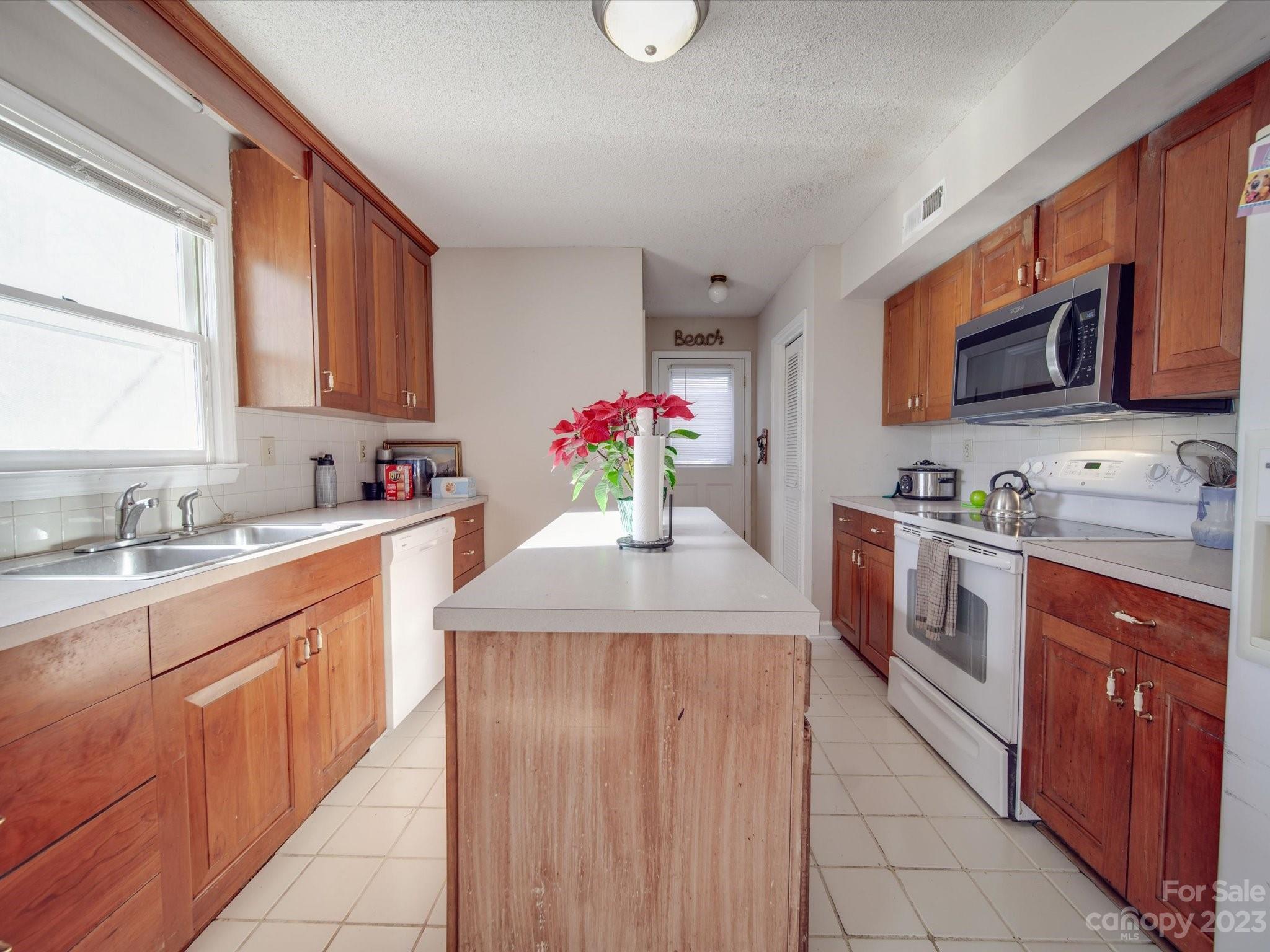8009 Lighthouse Way Indian Trail, NC 28079 - Photo 8 of 26 a kitchen with stainless steel appliances granite countertop a sink counter space cabinets and a large window
