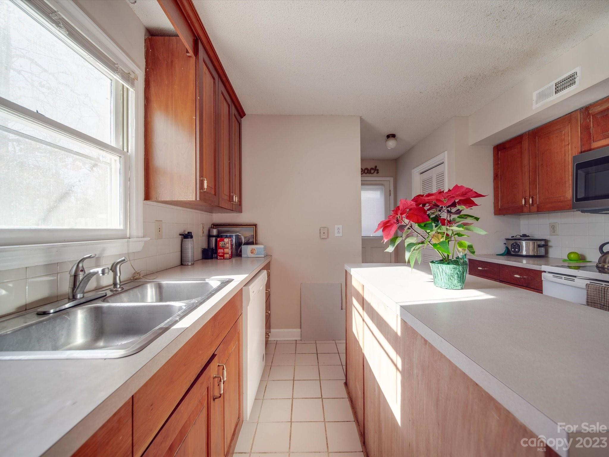 8009 Lighthouse Way Indian Trail, NC 28079 - Photo 10 of 26 a kitchen with a sink stove and cabinets