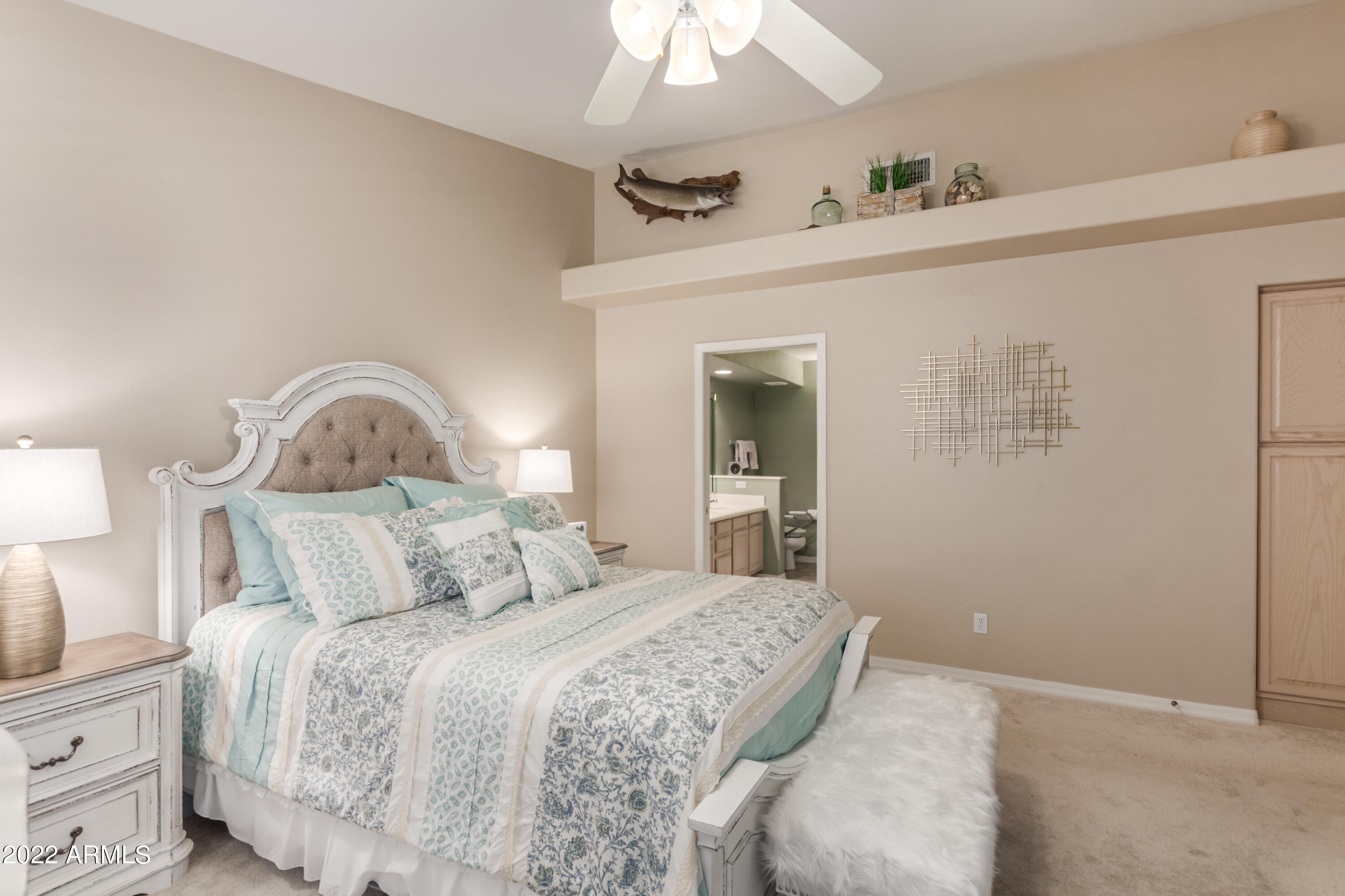 5830 East McKellips Road, Unit 76 Mesa, AZ 85215 - Photo 20 of 33 a bedroom with a bed and a chandelier