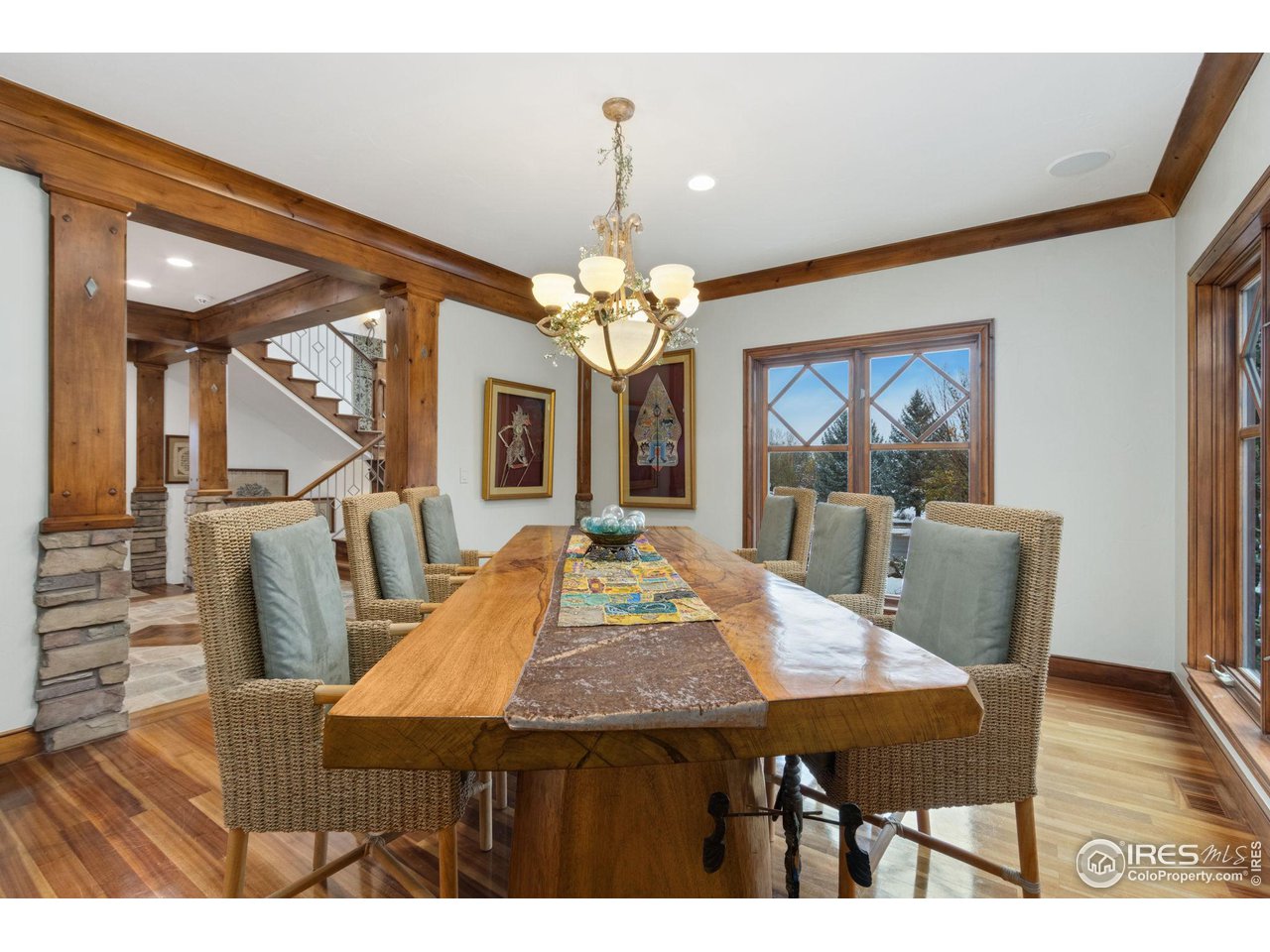 8467 Golden Eagle Road Fort Collins, CO 80528 - Photo 11 of 40 a view of a dining room with furniture and wooden floor