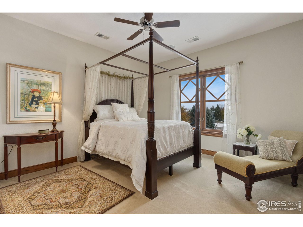 8467 Golden Eagle Road Fort Collins, CO 80528 - Photo 25 of 40 a bedroom with a bed a chandelier and a window