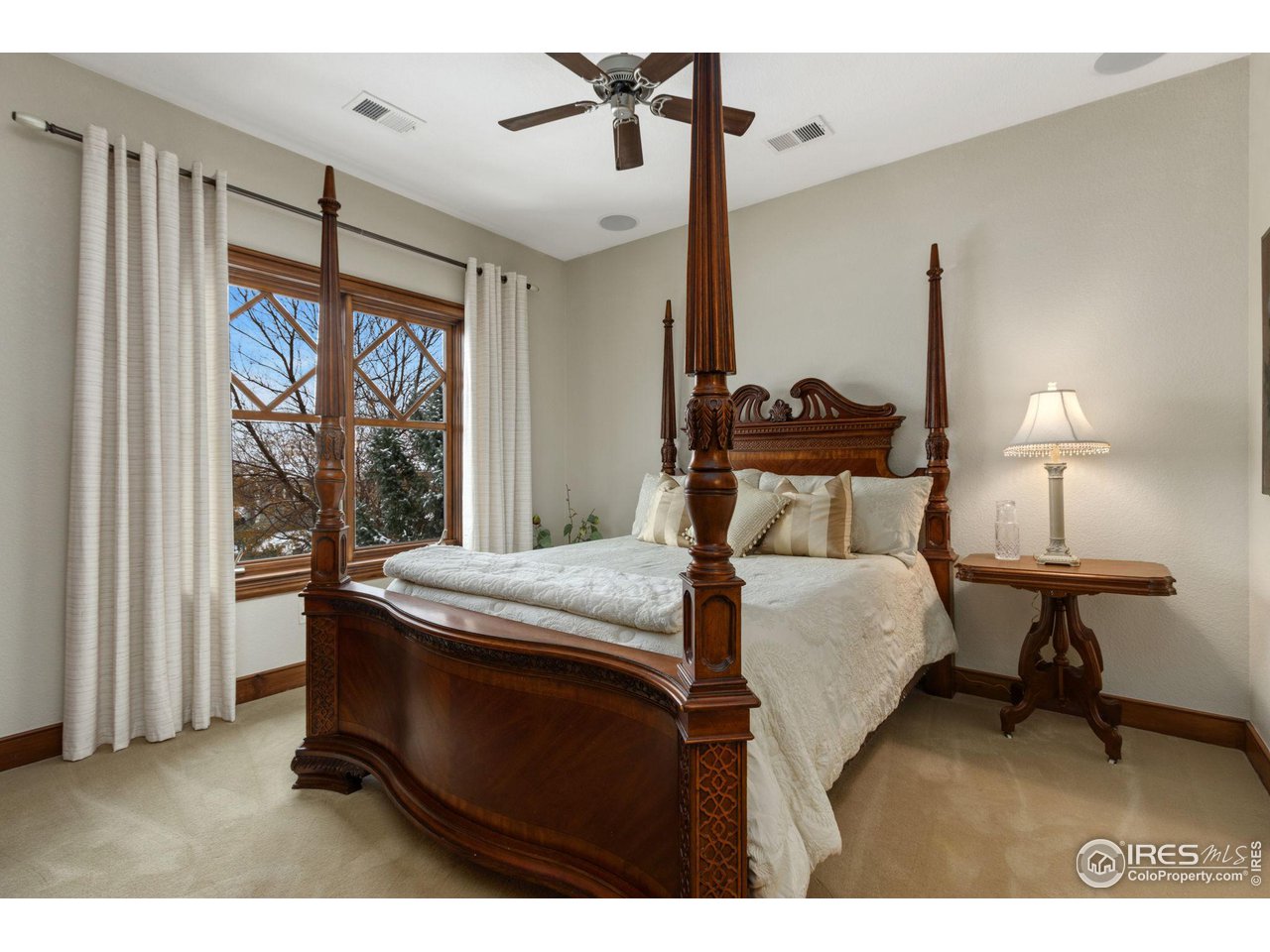 8467 Golden Eagle Road Fort Collins, CO 80528 - Photo 27 of 40 a bedroom with a bed window and lamp