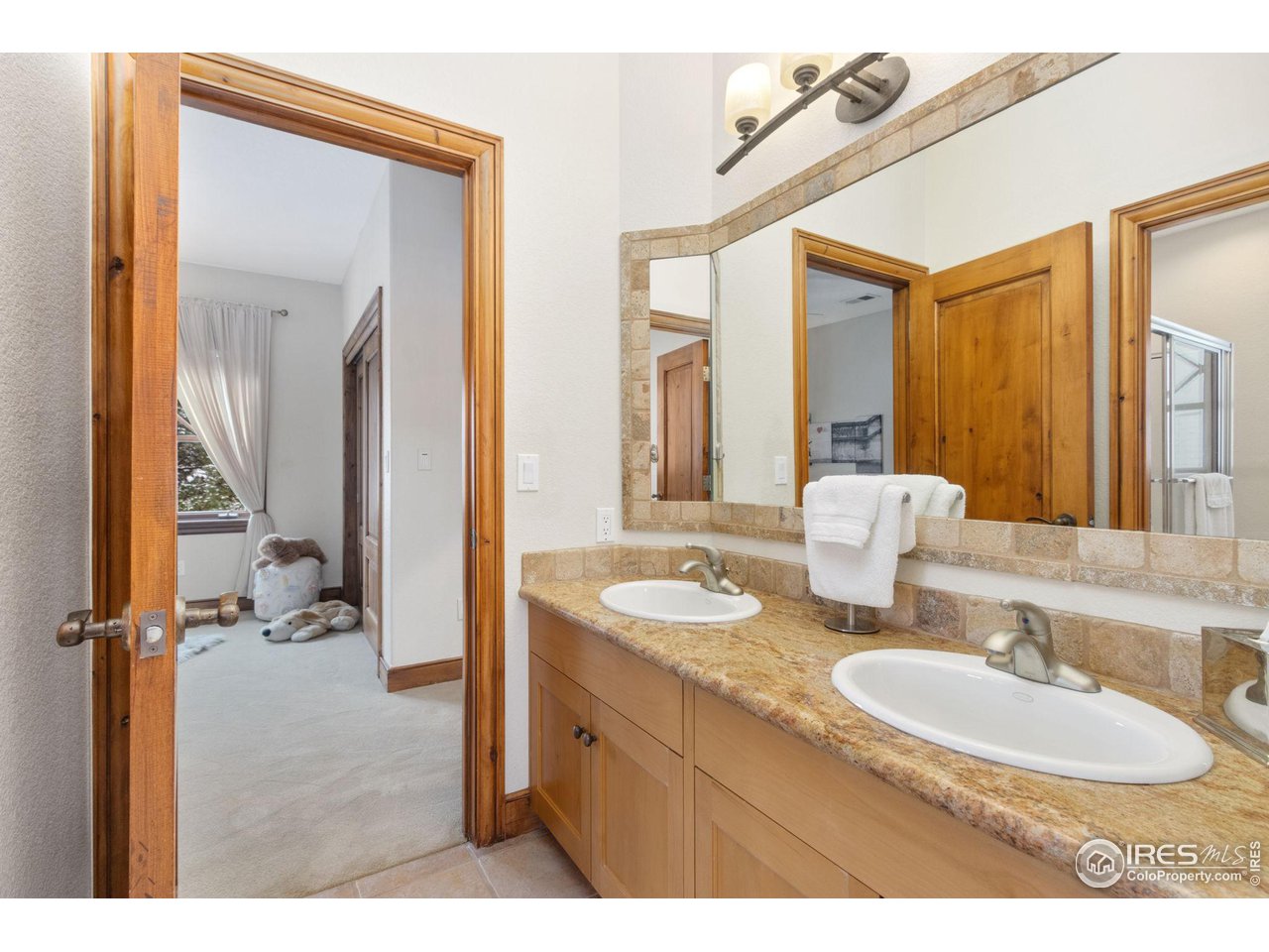 8467 Golden Eagle Road Fort Collins, CO 80528 - Photo 28 of 40 a bathroom with a sink and a mirror