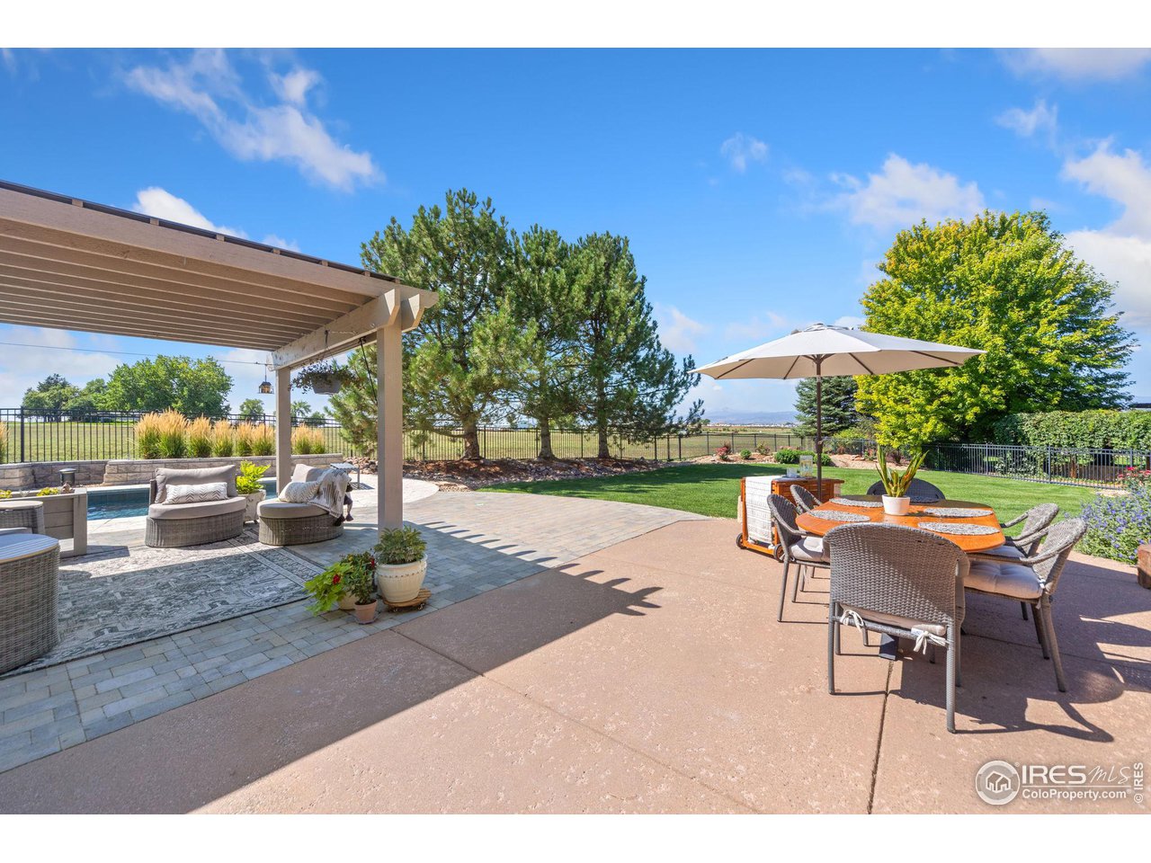8467 Golden Eagle Road Fort Collins, CO 80528 - Photo 38 of 40 a swimming pool with outdoor seating and yard