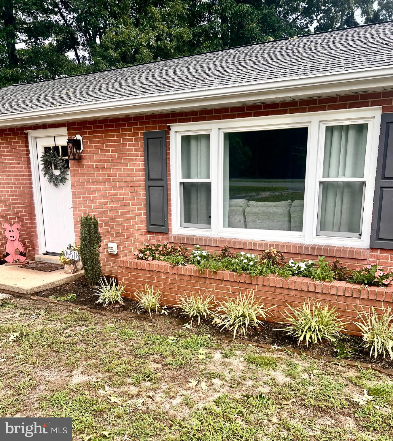 26576 Three Notch Road Mechanicsville, MD 20659 - Photo 3 of 20 Charming brick facade with lush greenery.