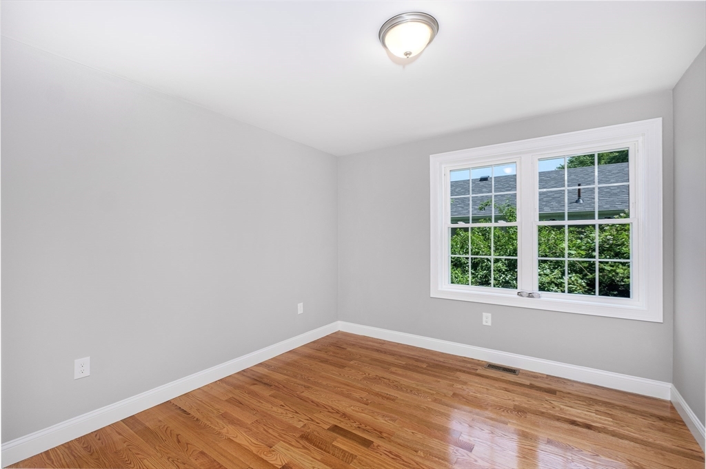216 Vane Street, Unit 1 Revere, MA 02151 - Photo 13 of 22 an empty room with wooden floor and windows