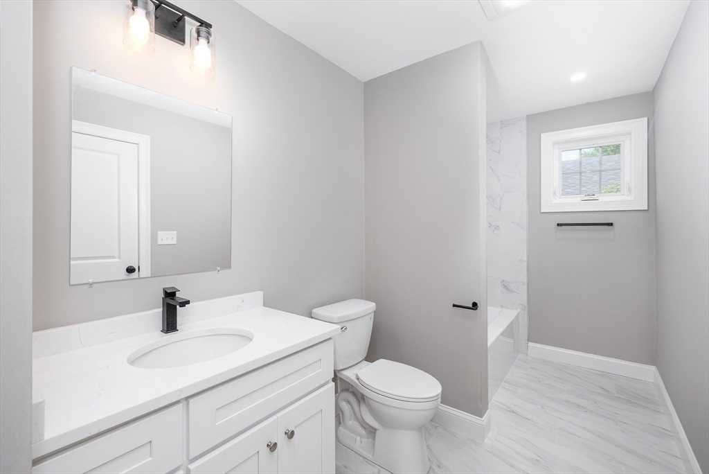216 Vane Street, Unit 1 Revere, MA 02151 - Photo 16 of 22 a bathroom with a sink toilet and vanity