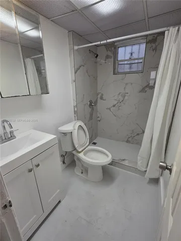a white toilet sitting next to a bathroom sink
