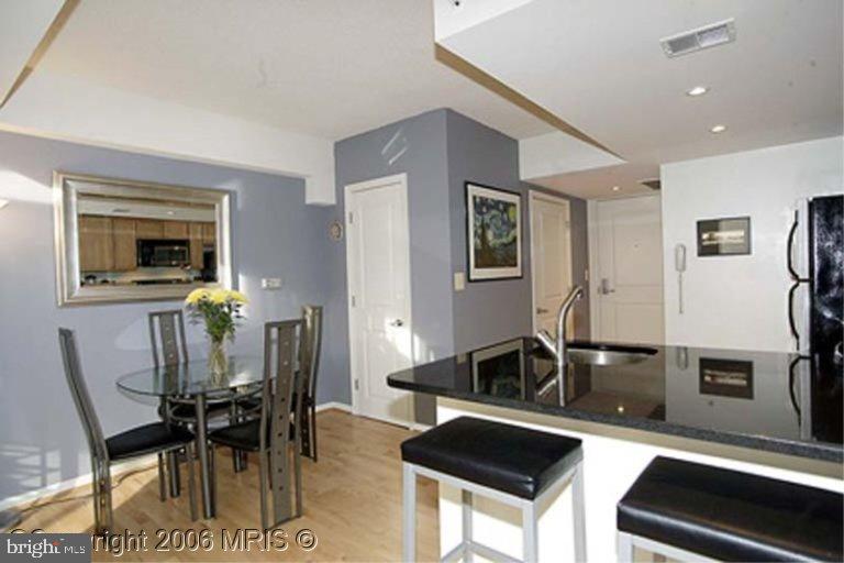 a kitchen with granite countertop a table and chairs in it