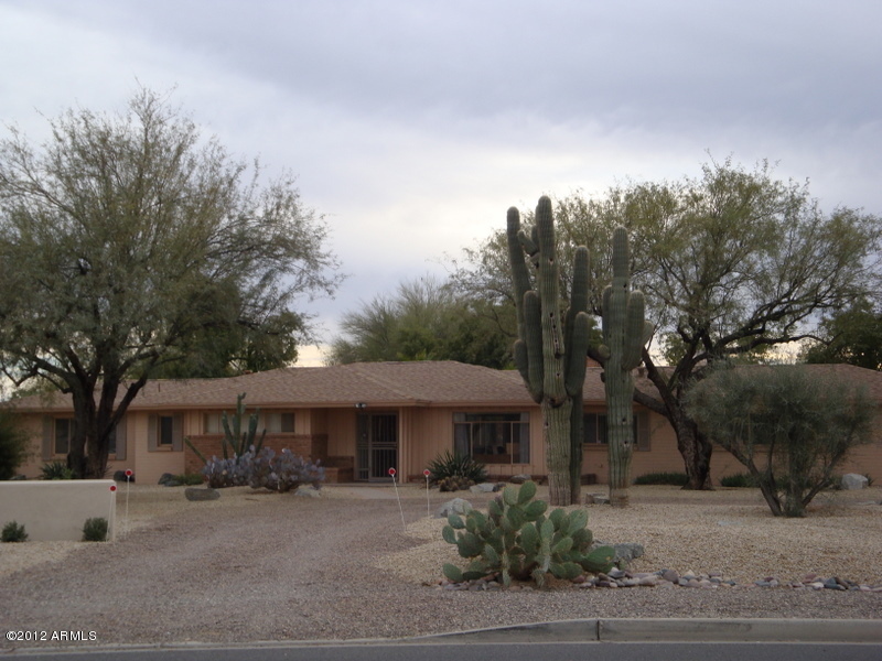 6933 East Doubletree Ranch Road Paradise Valley, AZ 85253 - Photo 1 of 30 a yellow house with trees in front of it