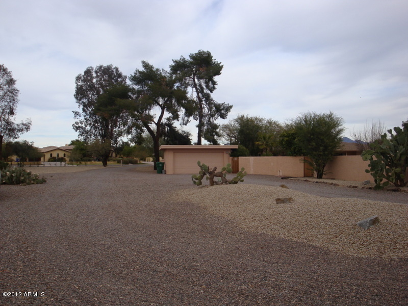 6933 East Doubletree Ranch Road Paradise Valley, AZ 85253 - Photo 16 of 30 a backyard of a house with lots of green space and trees in the background