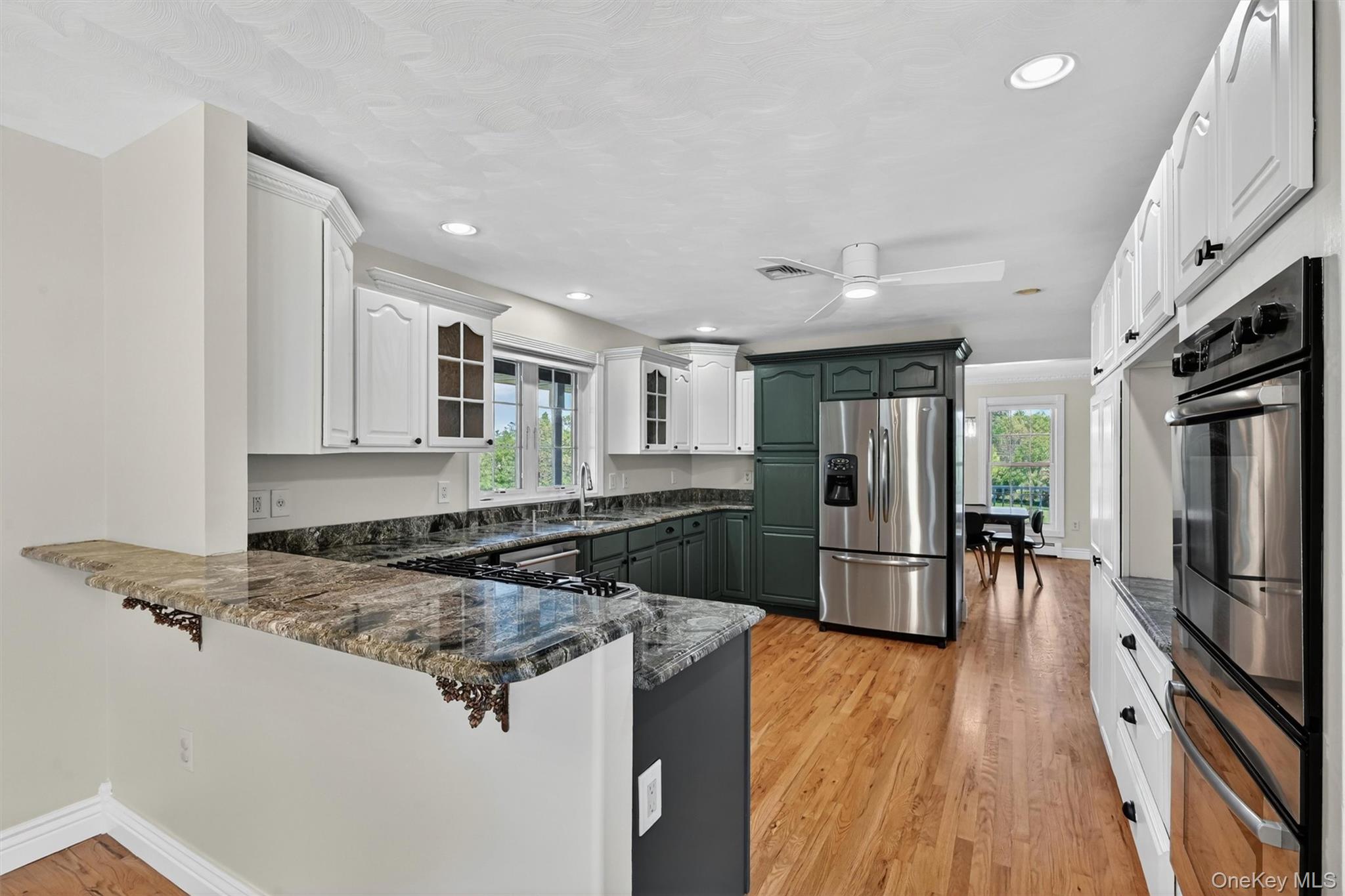 954 Ridgebury Road New Hampton, NY 10958 - Photo 18 of 45 The kitchen offers a warm and functional layout, with generous cabinetry, rich countertops, and an easy flow into the nearby dining space.