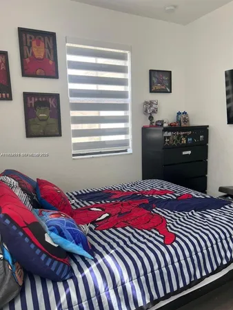 a bedroom with a bed and a dresser in it