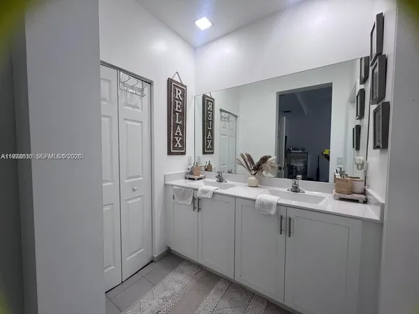 a bathroom with a double vanity sink and mirror