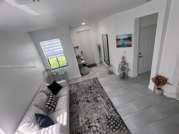 a view of living room with furniture and a rug