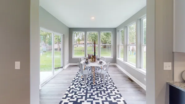 a living room with furniture and large windows