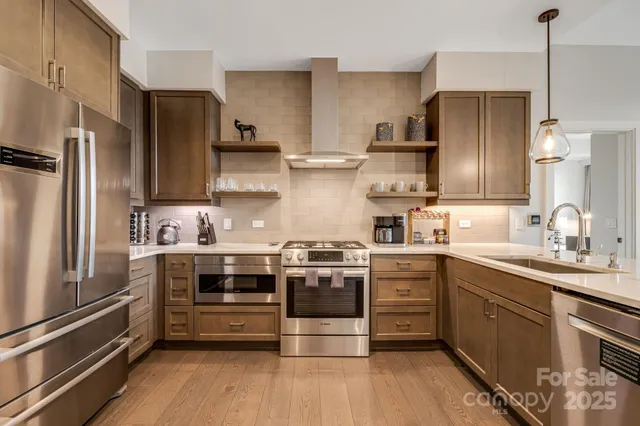 a kitchen with stainless steel appliances a stove and a refrigerator