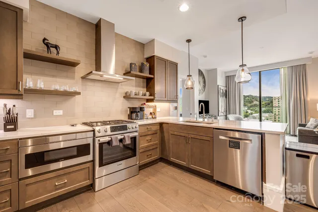 a kitchen with stainless steel appliances granite countertop a stove and a sink