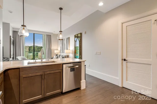 a kitchen with a sink stove and wooden floor