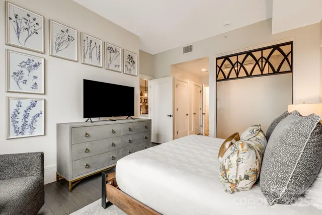 a bedroom with furniture and a flat screen tv