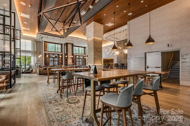 a dining room with stainless steel appliances kitchen island a table and chairs