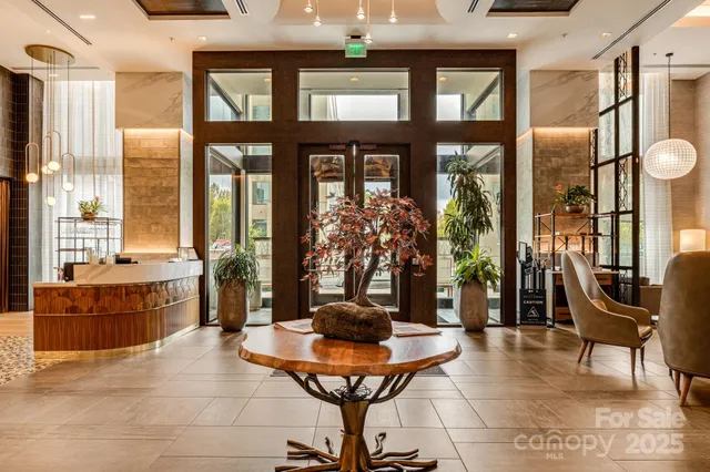 a living room with furniture and large windows